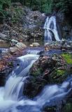 Long exposure of the Rhaeadr Mawddach waterfalls cascading down a rocky mountainside, Wales, UK